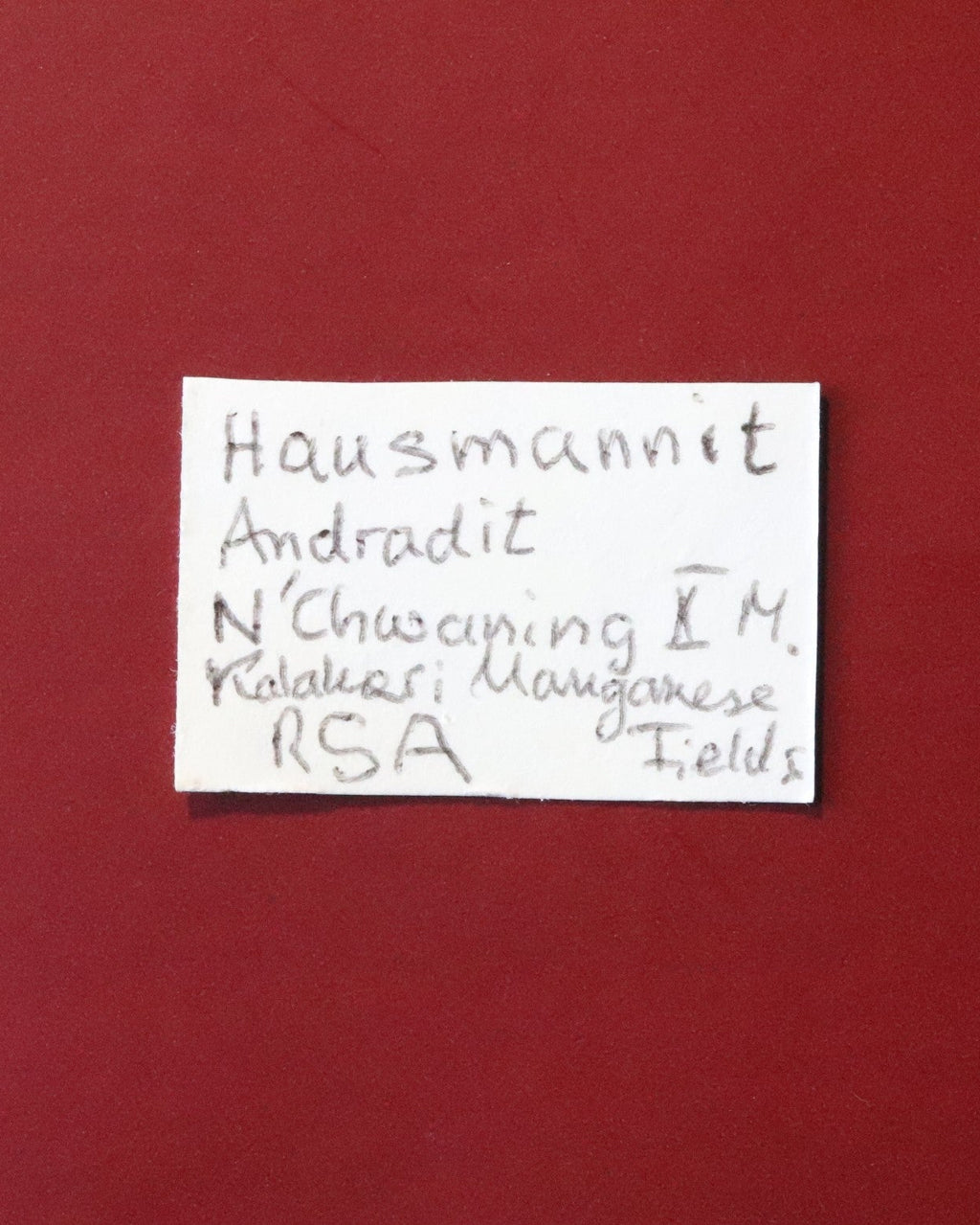 Front of label for Hausmannite with Andradite from N'Chwaning II, Kalahari Manganese Fields, South Africa