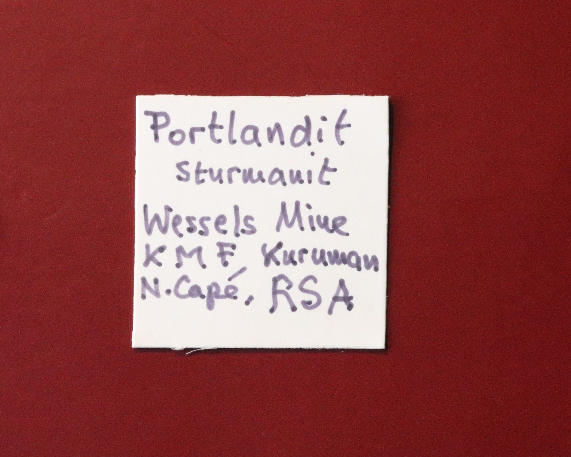 Front of label for nice combination of Portlandite with Sturmanite from Wessels Mine, Kalahari Manganese Fields, South Africa