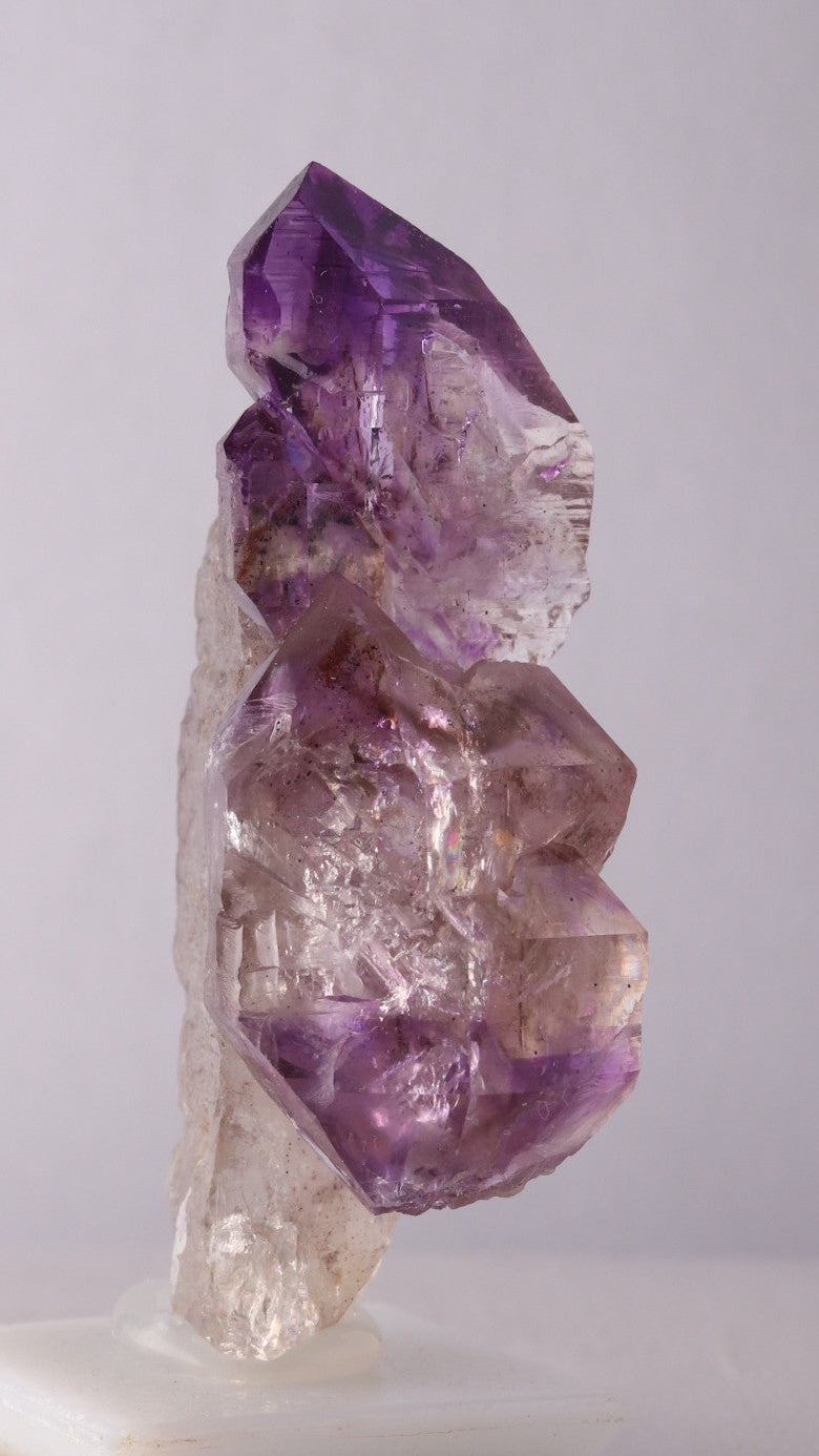 First side view of Amethyst Sceptres on a Quartz Point