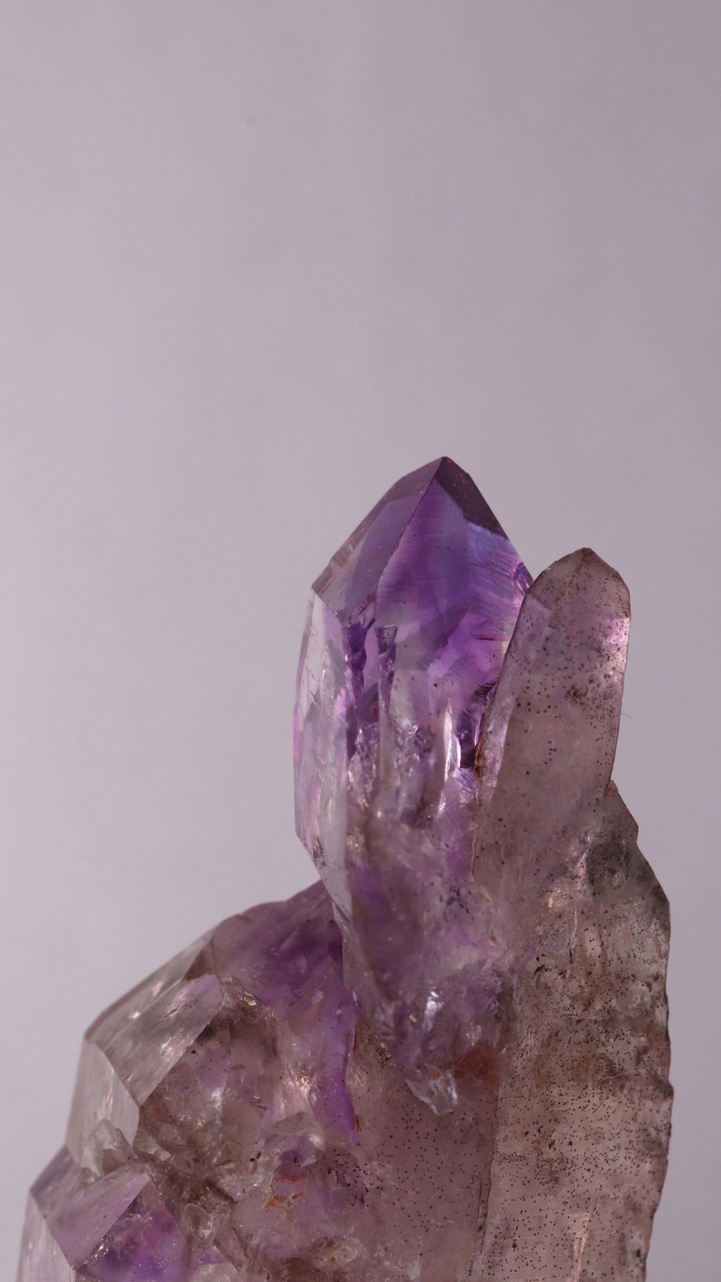 Side view of Amethyst sceptre on a Quartz Point