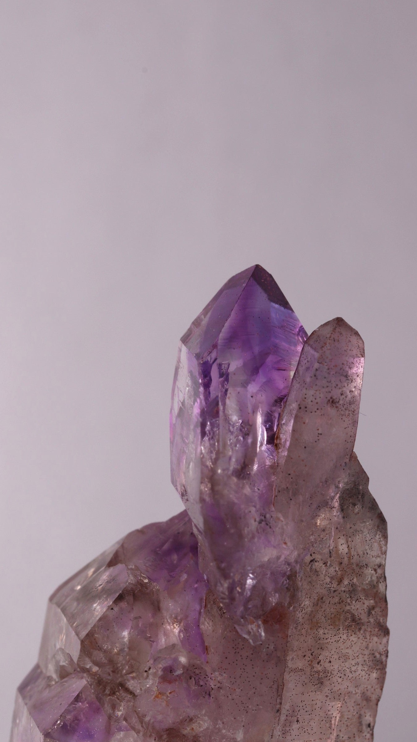 Side view of Amethyst sceptre on a Quartz Point