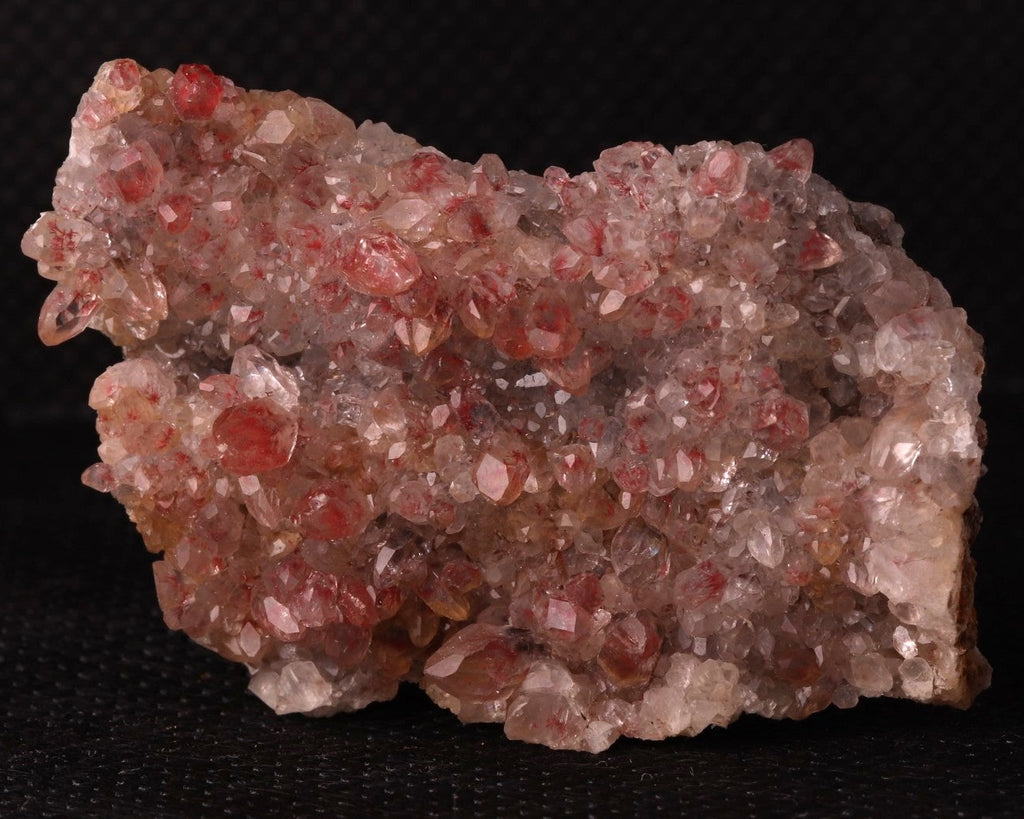 Front view of Cinnabar included in Calcite from N'Chwaning II, Kalahari Manganese Fields, South Africa