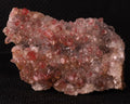 Front view of Cinnabar included in Calcite from N'Chwaning II, Kalahari Manganese Fields, South Africa