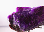 Close-up view of light shinning through deep purple Sugilite mineral specimen from Wessels Mine, South Africa