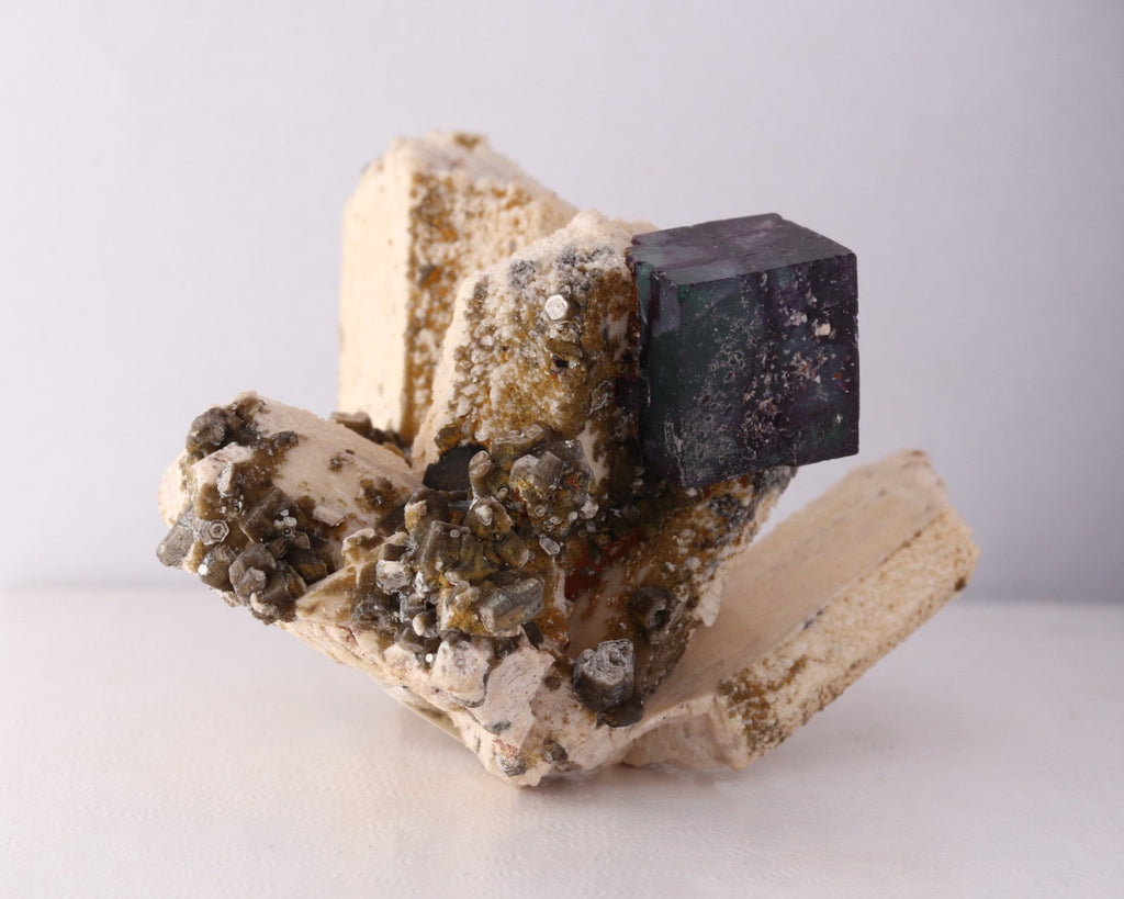 Slight side front view of gorgeous blue-purple Fluorite cube on Feldspar from Erongo Region, Namibia