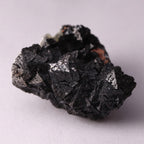 Side view of Hausmannite, Ettringite and Andradite mineral specimen from N'Chwaning II, Kalahari Manganese Fields, South Africa