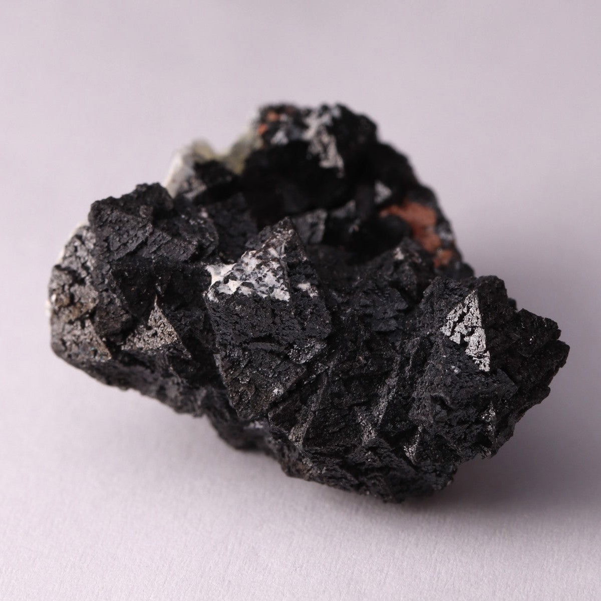 Side view of Hausmannite, Ettringite and Andradite mineral specimen from N'Chwaning II, Kalahari Manganese Fields, South Africa