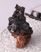 Side view of Hausmannite thumbnail from N'Chwaning, South Africa. Ex. Clive Queit.