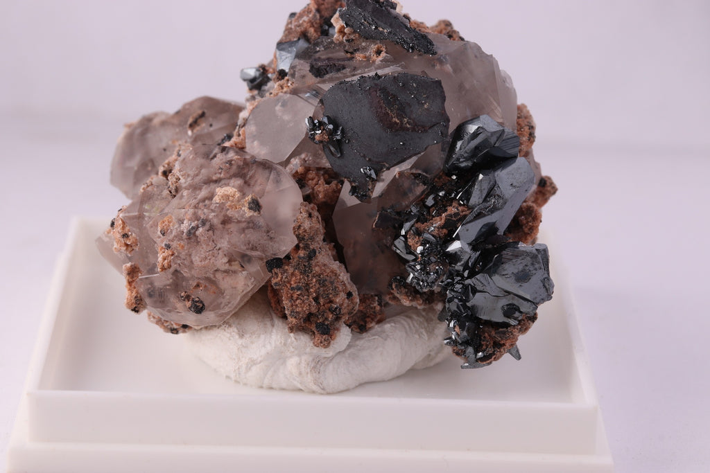 Close-up front view of beautiful lustrous Hematite with Calcite mineral specimen from N'Chwaning II, KMF (Kalahari Manganese Fields), South Africa