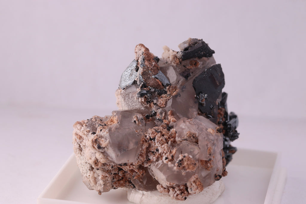 Close-up side view of beautiful lustrous Hematite with Calcite mineral specimen from N'Chwaning II, KMF (Kalahari Manganese Fields), South Africa