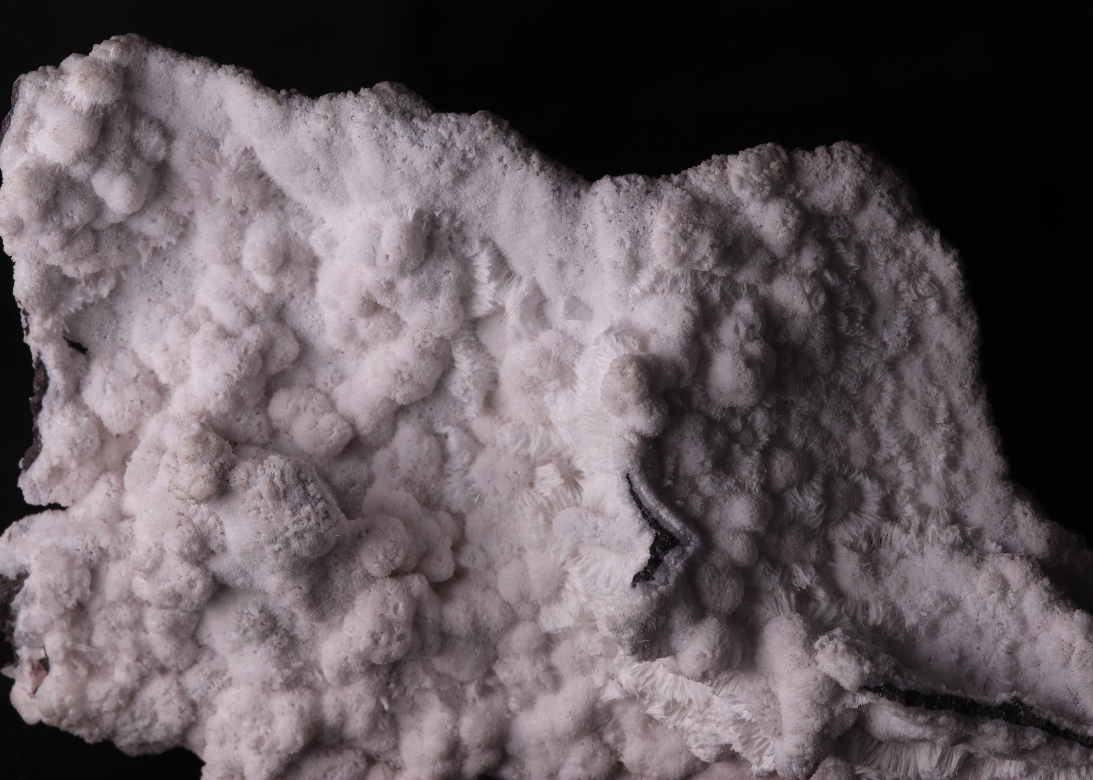 Close-up back view of fluorescent Mangano-Calcite mineral specimen from N'Chwaning II, Kalahari Manganese Fields, South Africa