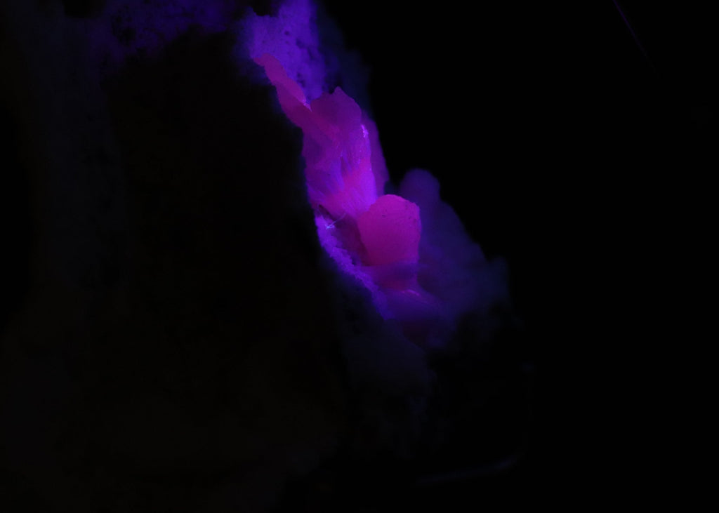 Close-up side view of fluorescent Mangano-Calcite mineral specimen from N'Chwaning II, Kalahari Manganese Fields, South Africa