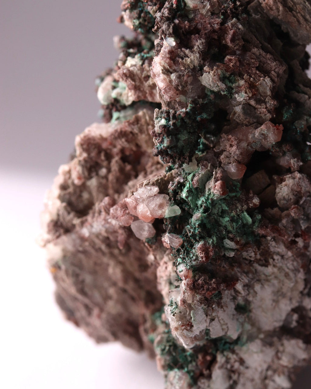 Close-up view of Native Copper with Calcite and Malachite mineral specimen from Tsumeb, Oshikoto Region, Namibia