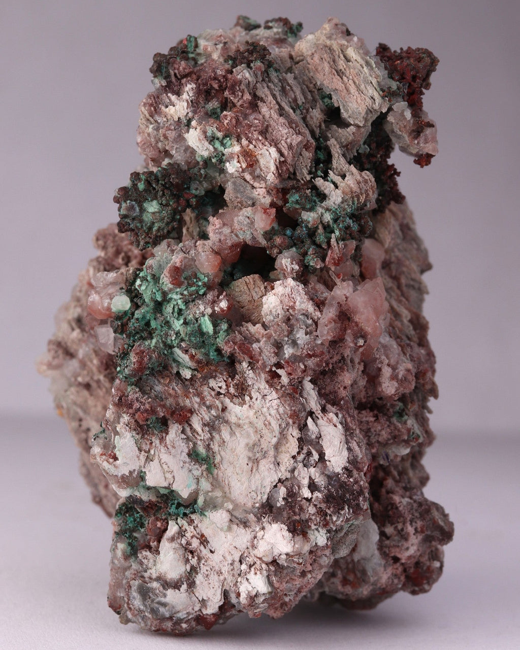 Close-up side view of Native Copper with Calcite and Malachite mineral specimen from Tsumeb, Oshikoto Region, Namibia