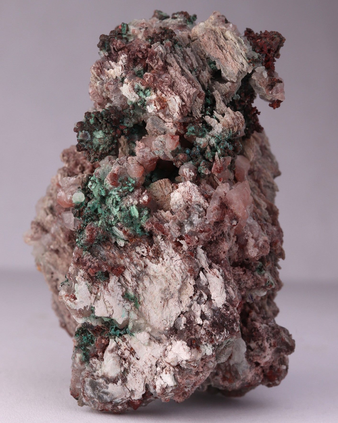 Close-up side view of Native Copper with Calcite and Malachite mineral specimen from Tsumeb, Oshikoto Region, Namibia