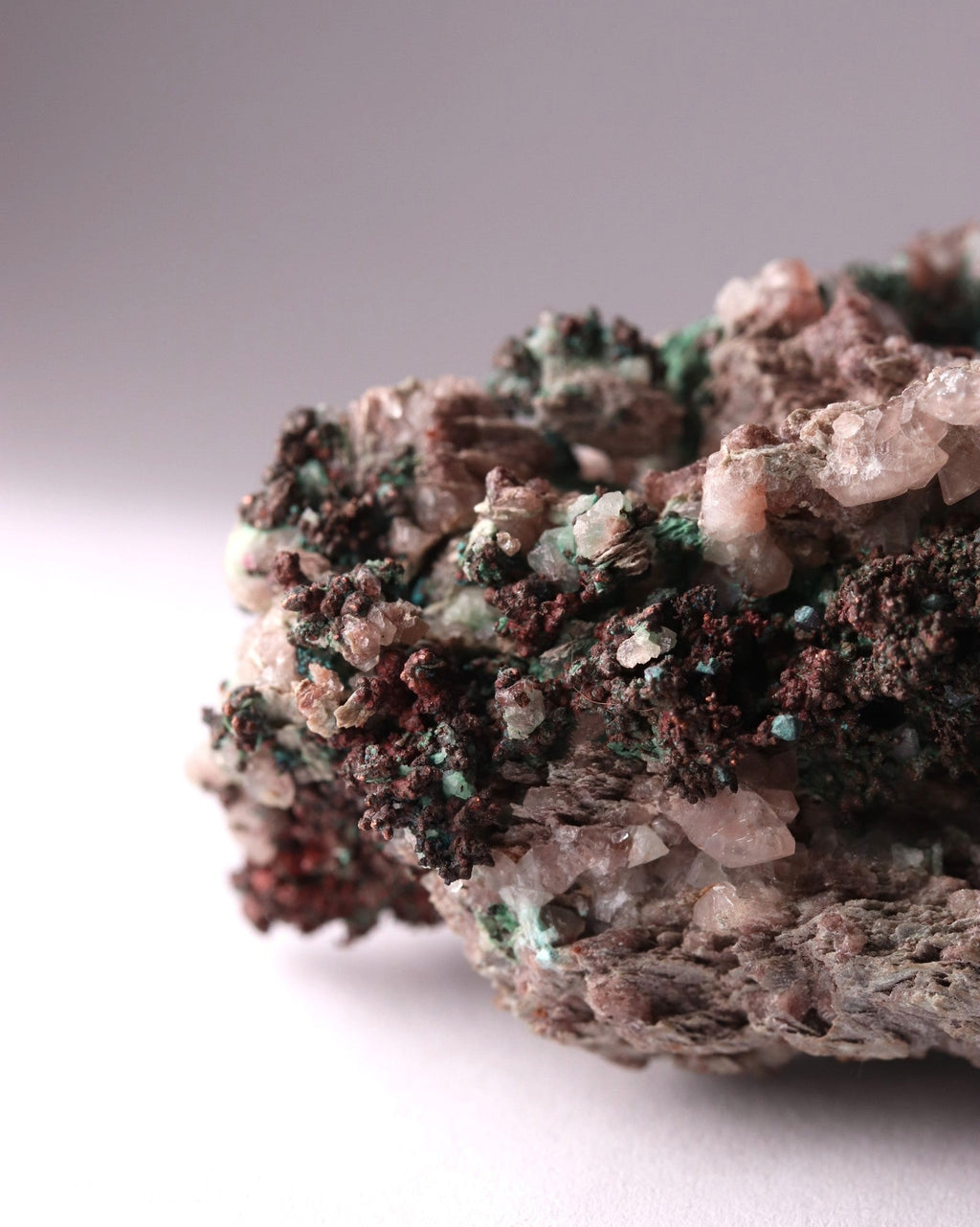 Close-up view of Native Copper with Calcite and Malachite mineral specimen from Tsumeb, Oshikoto Region, Namibia