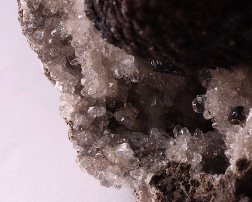 Close-up view of dark brown Olmiite with Calcite mineral specimen from N'Chwaning, Kalahari Manganese Fields, South Africa