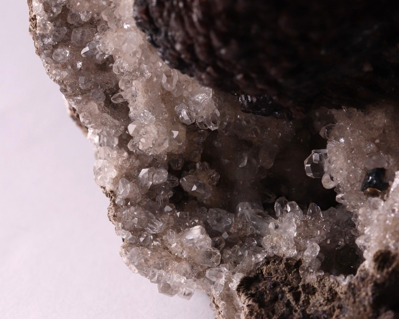 Close-up view of dark brown Olmiite with Calcite mineral specimen from N'Chwaning, Kalahari Manganese Fields, South Africa