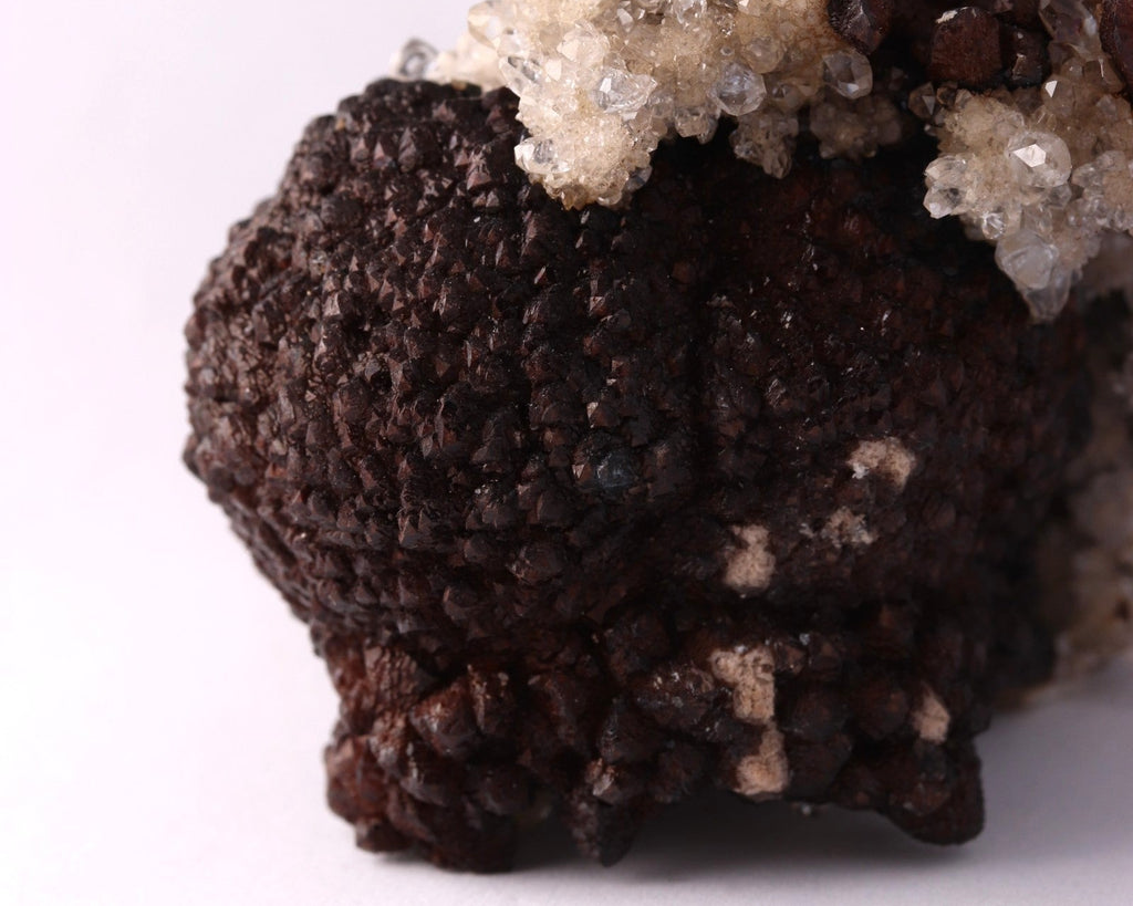 Close-up view of dark brown Olmiite with Calcite mineral specimen from N'Chwaning, Kalahari Manganese Fields, South Africa