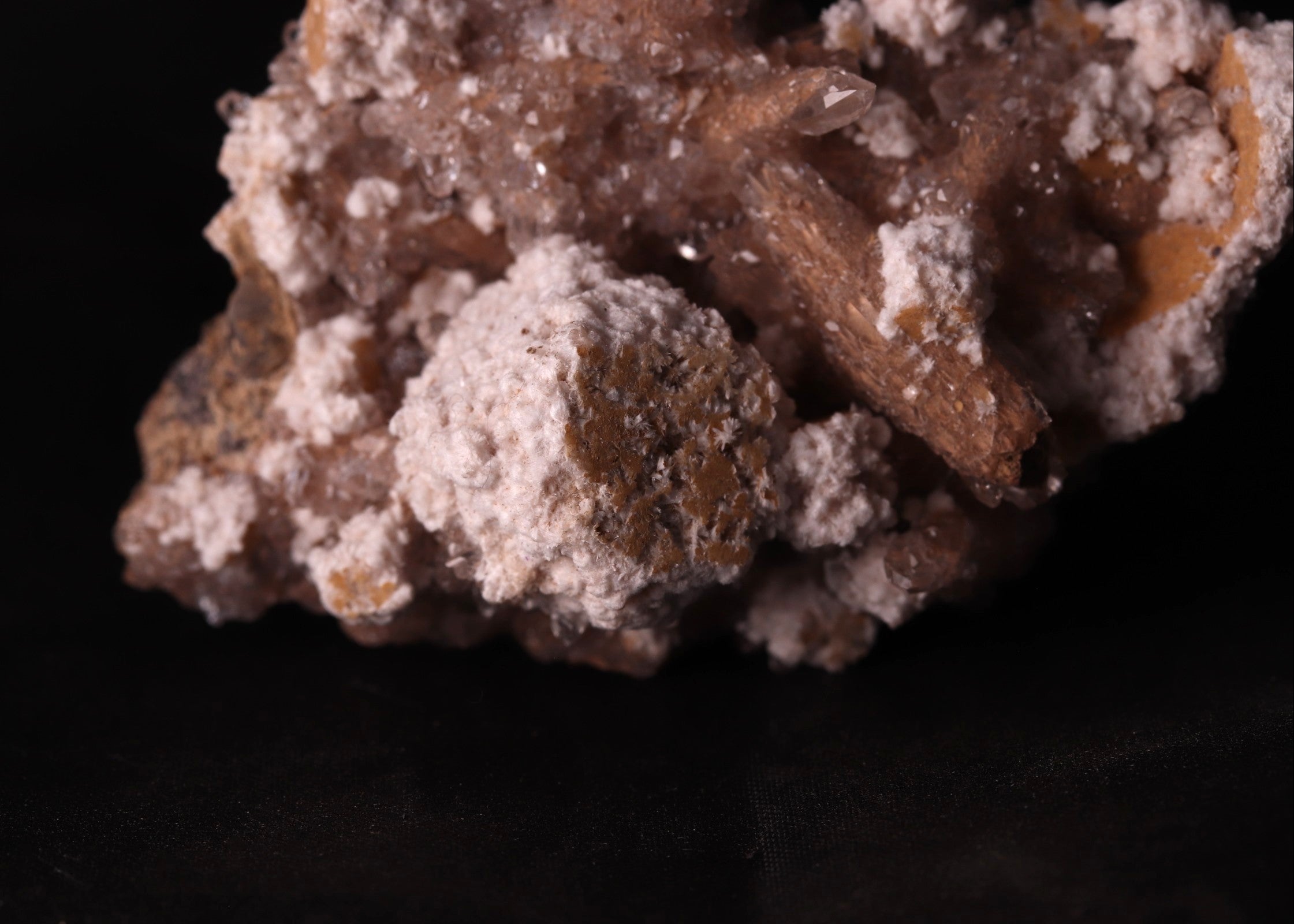 Close-up view of Oyelite with Calcite mineral specimen from N'Chwaning II, Kalahari Manganese Fields, South Africa