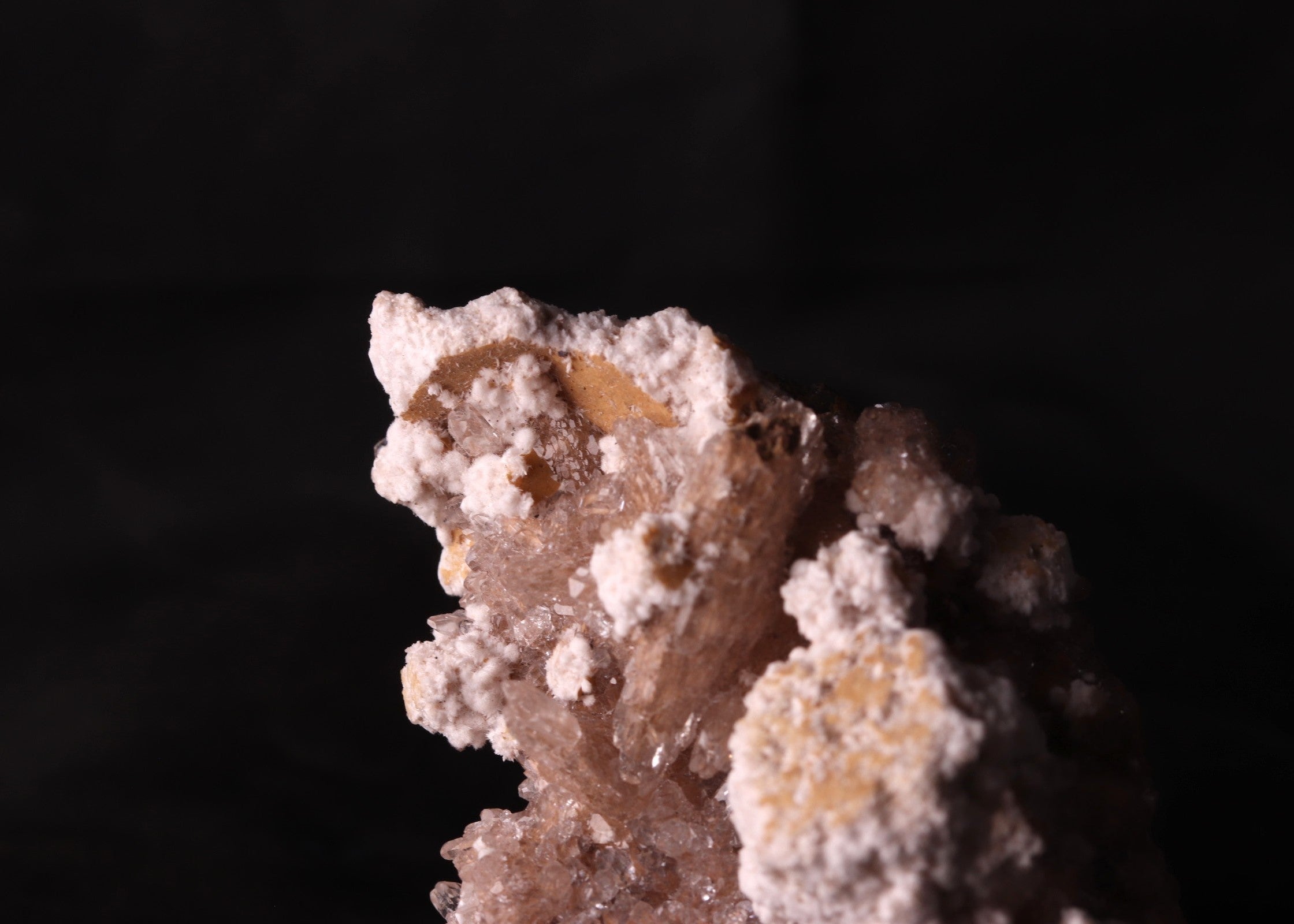 Close-up view of Oyelite with Calcite mineral specimen from N'Chwaning II, Kalahari Manganese Fields, South Africa