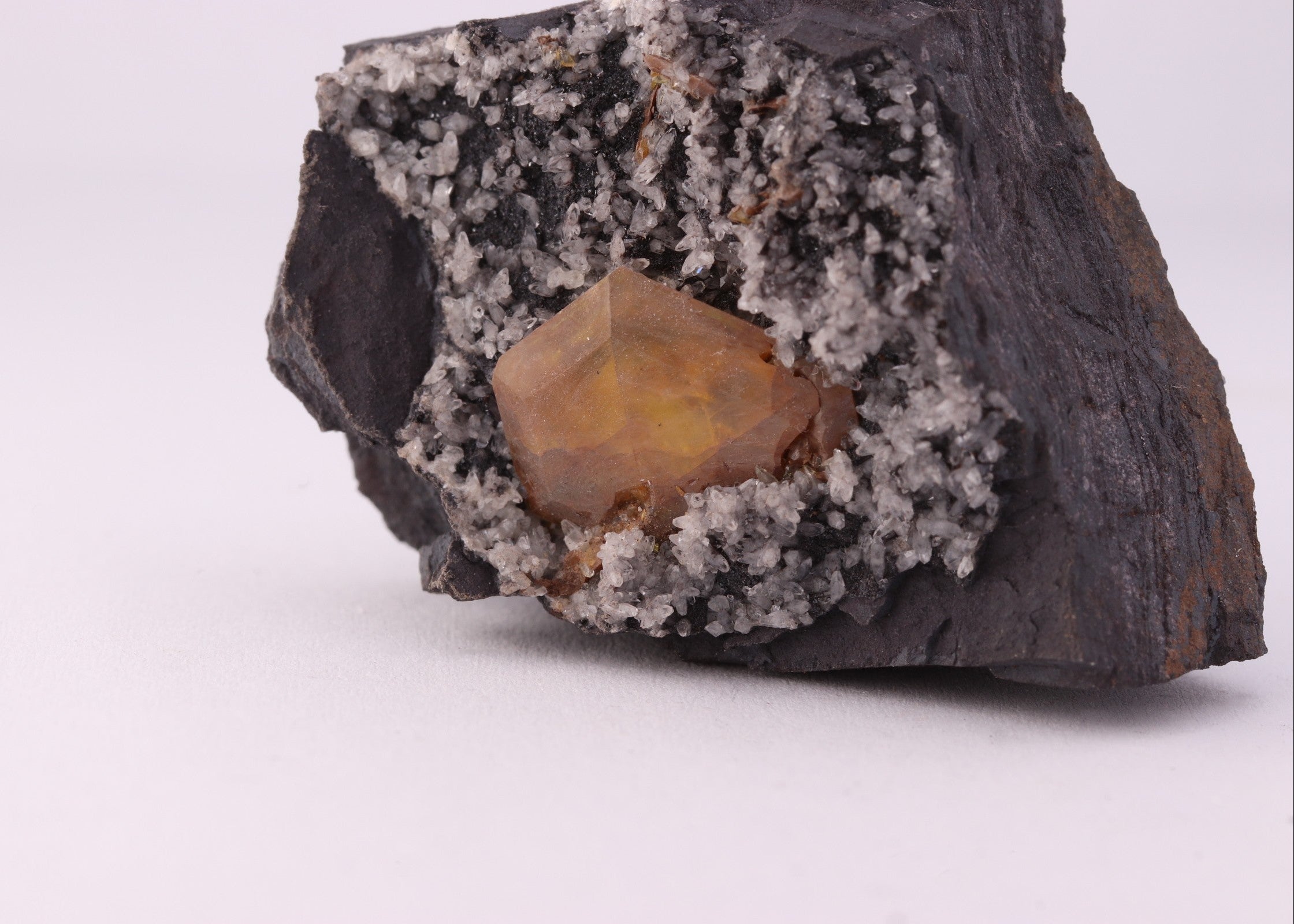 Close up of view of large gemmy Sturmanite crystal with Calcite on matrix from KMF (Kalahari Manganese Field), South Africa.