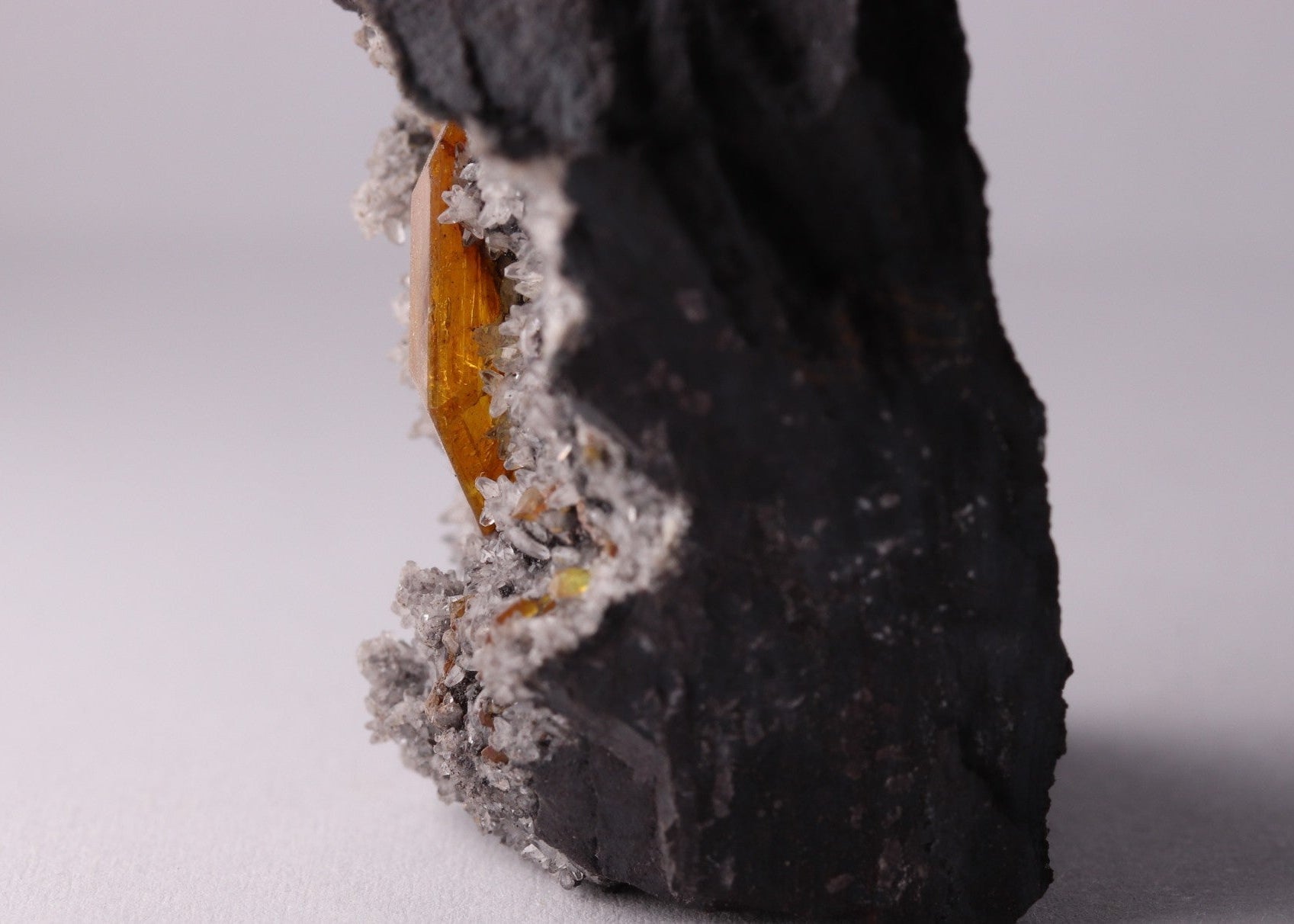 Very close-up side view of large gemmy Sturmanite crystal with Calcite on matrix from KMF (Kalahari Manganese Field), South Africa.
