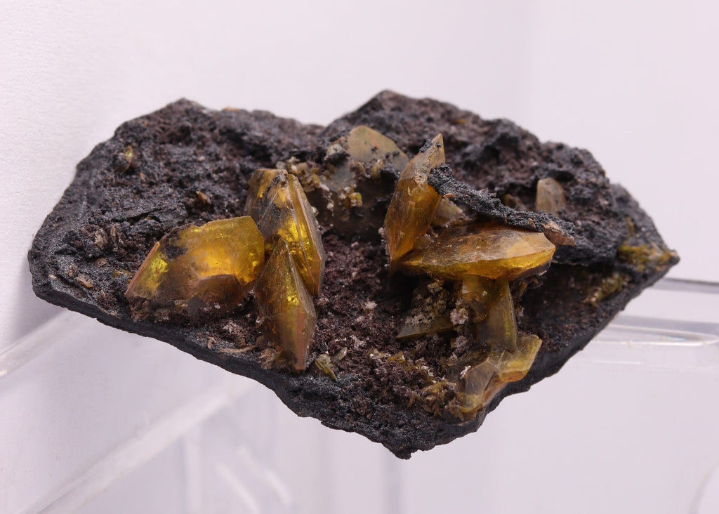 Light shining through multiple gemmy Sturmanite crystals on matrix. From KMF (Kalahari Manganese Field), South Africa.