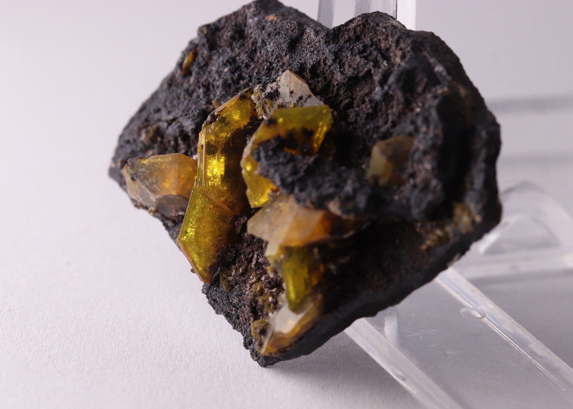 Close-up view of light shining through gemmy Sturmanite crystals on matrix. From KMF (Kalahari Manganese Field), South Africa.