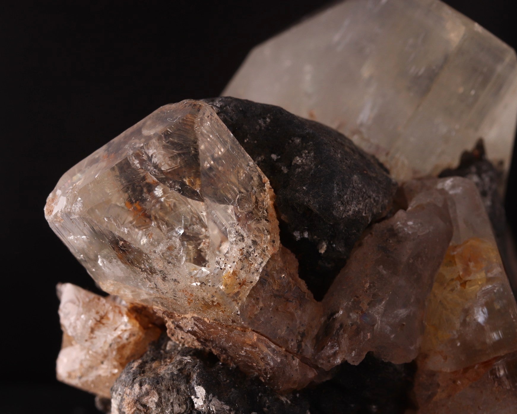Close-up view of stunning large Topaz crystals among Schorl.