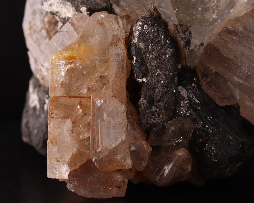 Close-up view of stunning large Topaz crystals among Schorl.